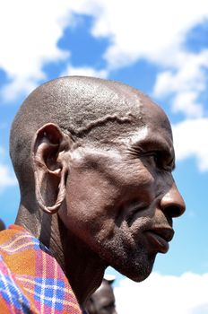 Masai Mara,Kenya-October 19 : Old African Masai warrior with jewelry in the Masai Mara Conservation Area. Masai are a semi-nomadic and pastoral people living in Kenya and the northern parts of Tanzania