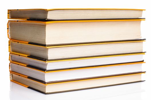 Big stack of yellow books isolated on white background