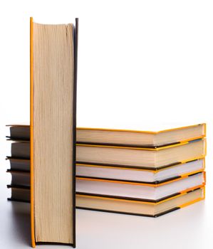 Big stack of yellow books isolated on white background