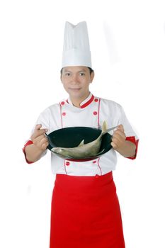 chef holding raw fish on a black frying pan isolated on white background