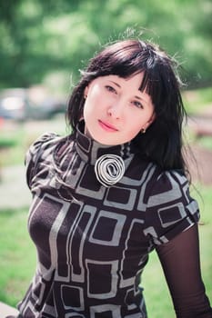 Beautiful thoughtful young woman outdoors on a warm summer day