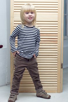 Blonde girl 3 years old dressed as a boy