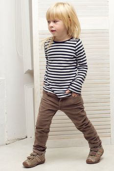 Blonde girl 3 years old dressed as a boy