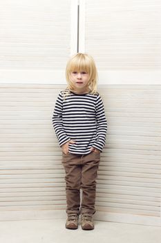 Blonde girl 3 years old dressed as a boy