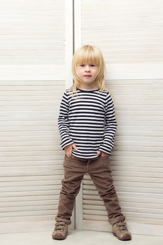Blonde girl 3 years old dressed as a boy