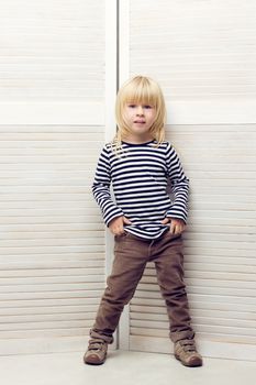 Blonde girl 3 years old dressed as a boy