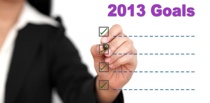 Asian business woman writing 2013 Goal List