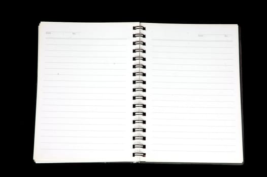 an opened notebook isolated on black background