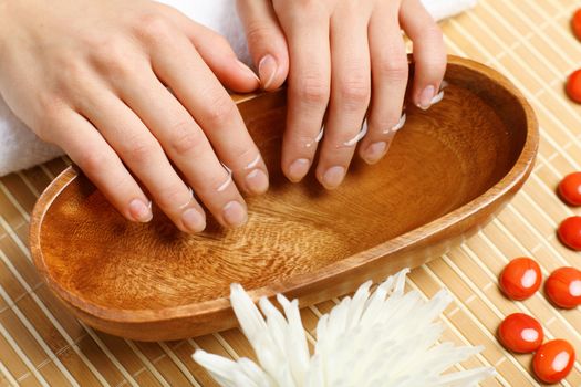 Young woman is getting manicure in a beauty salon