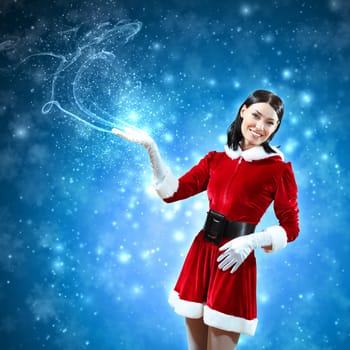 Portrait of beautiful girl wearing santa claus clothes on red background