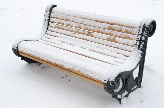 park bench covered by snow