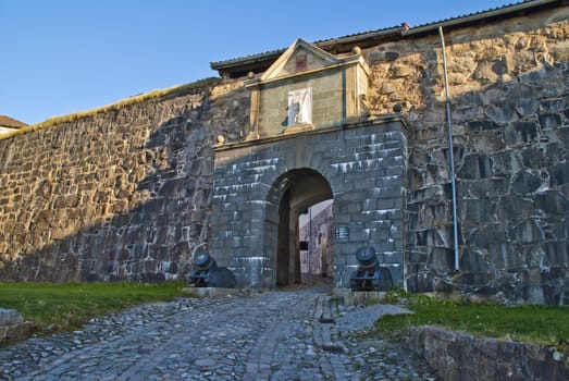 the gate through western curtain wall, the wall protects the citadel to the west and connects queen's bastion with prince george's bastion, the curtain wall was completed in 1671 and the vaults in 1737, image is shot near the main entrance to fredriksten