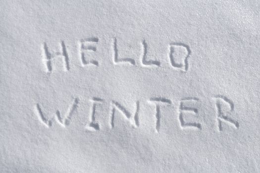 handwritten Hello Winter on the fresh snow background