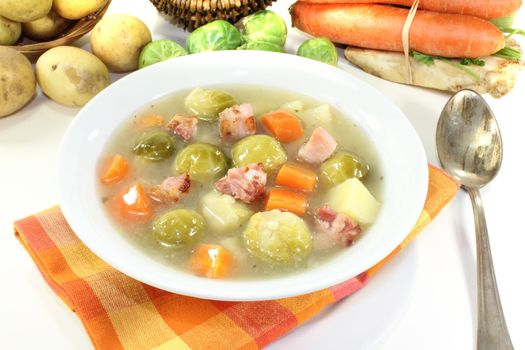 Brussels sprouts soup with potatoes, leeks, carrots, celery and bacon