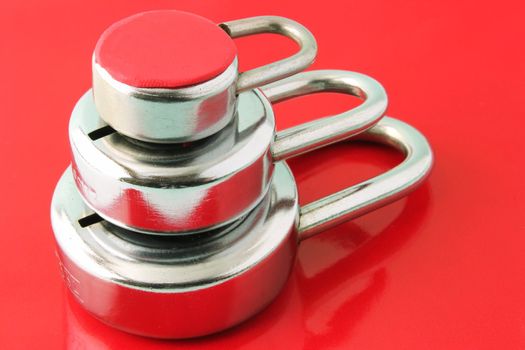 Three layers of security depicted with three padlocks on a red background