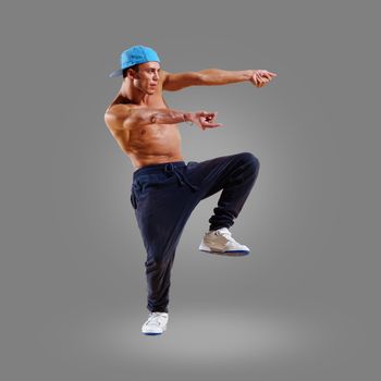 dancer of hip-hop on a gray background , motion