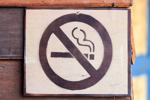 No smoking sign on the wooden wall.