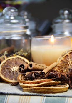 Tea, candle, cinnamon sticks and dry orange