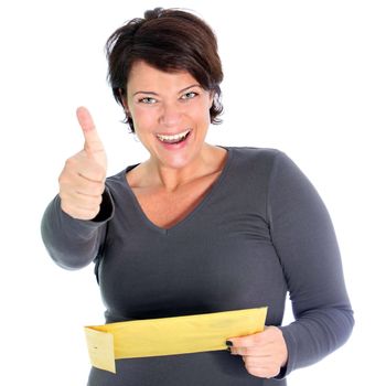 Attractive excited woman with a brown envelope in her hands giving a thumbs up gesture of success and victory isolated on white Attractive vivacious woman with a brown envelope in her hands giving a thumbs up gesture og success and victory