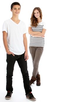 Full body studio portrait of two happy young trendy teenagers in smart casual clothes with the boy in the foreground and girl behind isolated on white