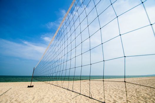 Torn beach volleyball net at tropical beach