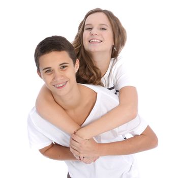 Affectionate playful young teenage boy and girl embracing and smiling isolated on white
