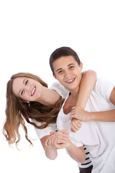 Vivacious laughing young teenage boy and girl having fun playing around together with the girls arms around the boys neck from behind isolated on white