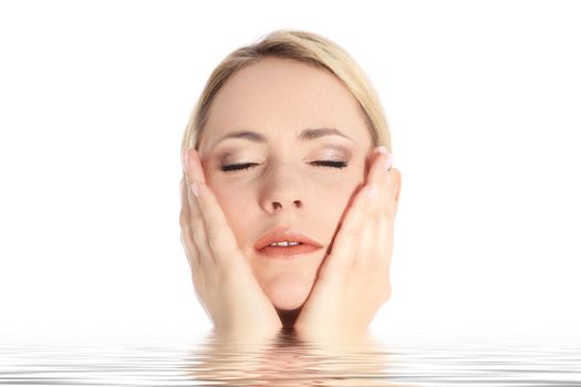 Studio portrait over white of a beautiful blonde woman, with eyes closed and gently caressing her own face, emerges from rippling water Studio portrait over white of a beautiful blonde woman, with eyes closed and gently caressing he own face, emerges from rippling water