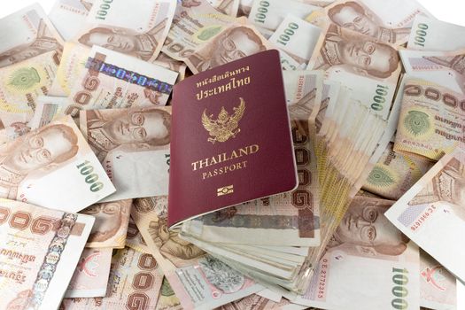 thailand passport and money banknotes as background.