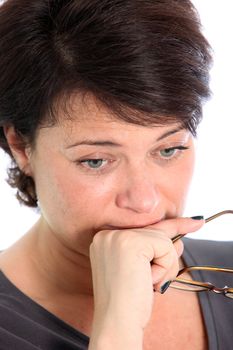 Portrait of worried middle aged woman on white background