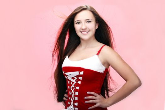 Portrait of young and beautiful smiling christmas girl in red