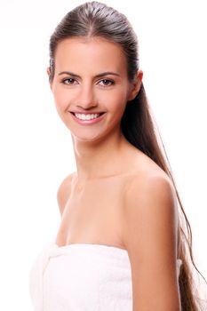 Portrait of beautiful smiling woman with cute smile in towel