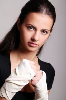 Portrait of beautiful woman with bandages ready for a fight