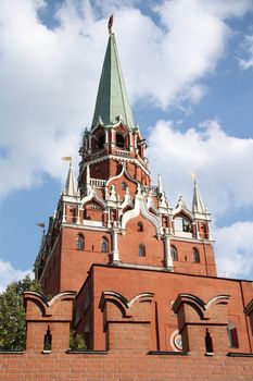 The Kremlin wall and the Troitskaya tower over blue cloudy sky, Moscow, Russia