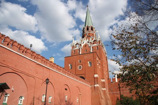 Moscow Kremlin wall and the Troitskaya tower over blue cloudy sky, Moscow, Russia