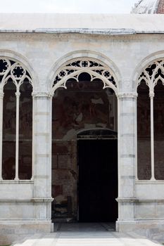 Gotic carved arch in the inner yard of Campo Santo in Pisa
