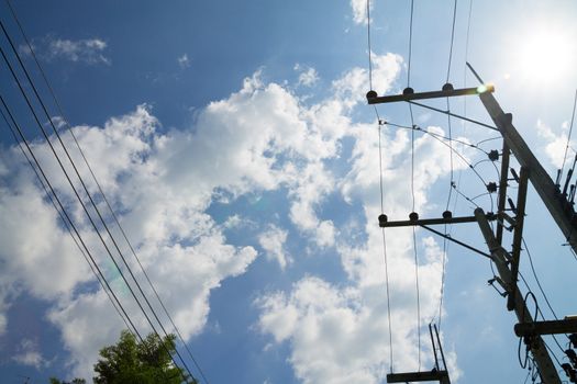 Electricity post with transformer on blue sky background