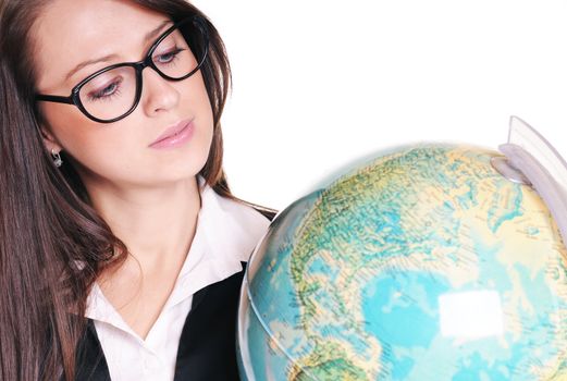 Pretty young teacher with globe on white background