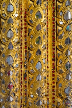 detail of golden wall in grand palace ,bangkok thailand