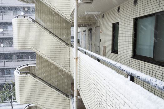 strong wet snowfall over residential building background in Tokyo