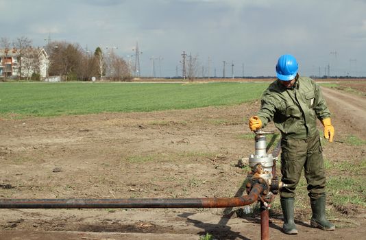 oil worker open pipeline valve