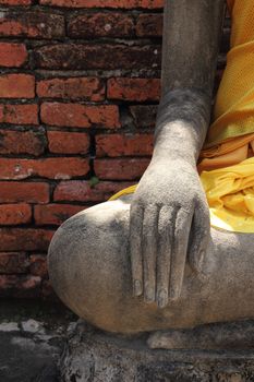 Close-up hand of Buddha statue at Wat Yai Chai Mongkhol, Ayutthaya, Thailand.
