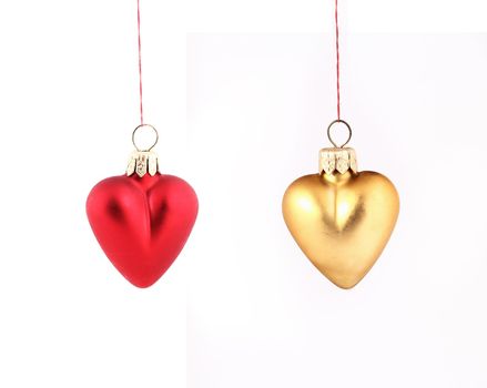 Hanging Christmas red and yellow hearts isolated on white background