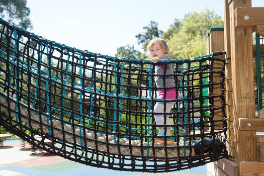 Having fun at playground in the park on sunny afternoon.