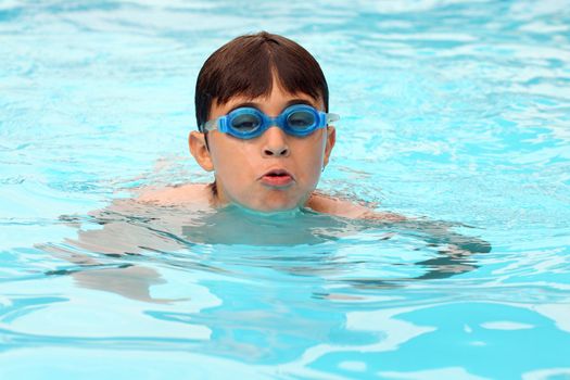 Young sportsman swimming in pool 