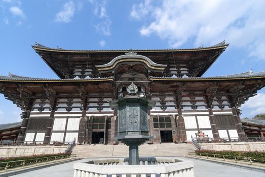 the world biggest wooden building - Todai-ji Temple in Nara, Japan with walking tourists, this building is 49 meters in height and is well-known as the Great Buddha hall