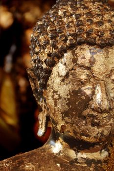 Close up buddha statue covered with gold leaves at Wat Yai Chai Mongkhol, Ayutthaya, Thailand
