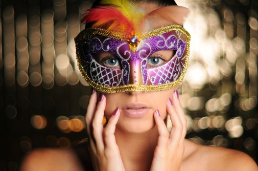 Beautiful young woman in carnival mask