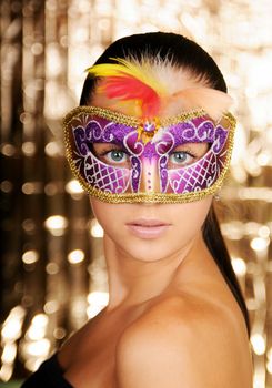 Beautiful young woman in carnival mask