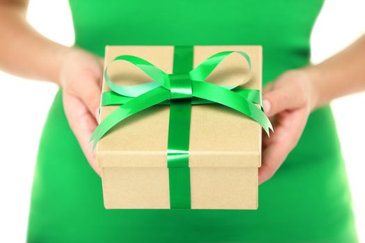 Gift / present. Woman hands showing and giving gifts. Closeup of present made of recycled carton and green ribbon on white background.